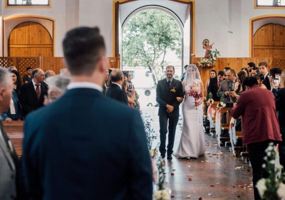 pexels-photo-33880480-33880480 Bride and father walking down the aisle in a traditional indoor wedding ceremony.